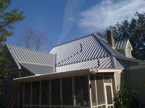 standing seam silver metal roof on traditional house fairfield ct|connecticut roofing company.